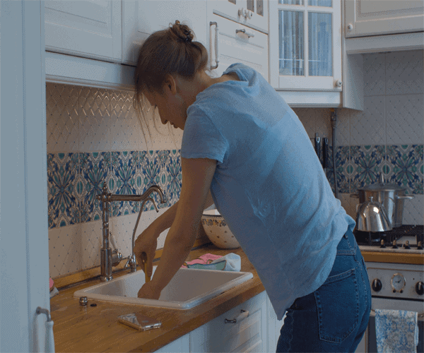 woman unclogging drain
